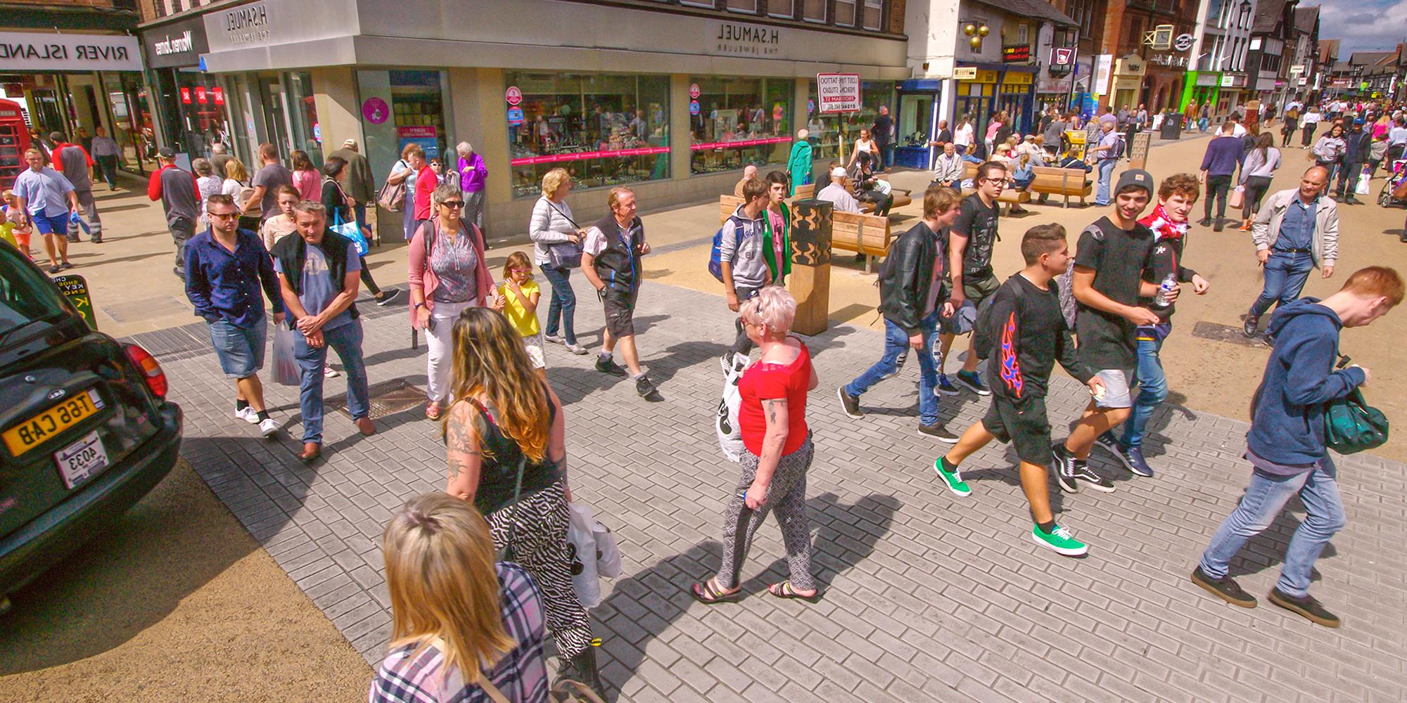 People walking through Frodsham Street Public Realm Chester, UK